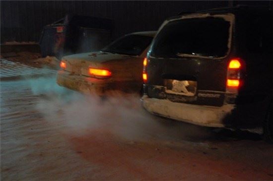Two Vehicles Warming up in a Parking Lot
